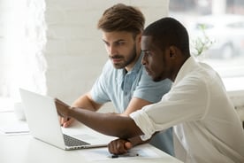 A training mentor helping a new hire onboard