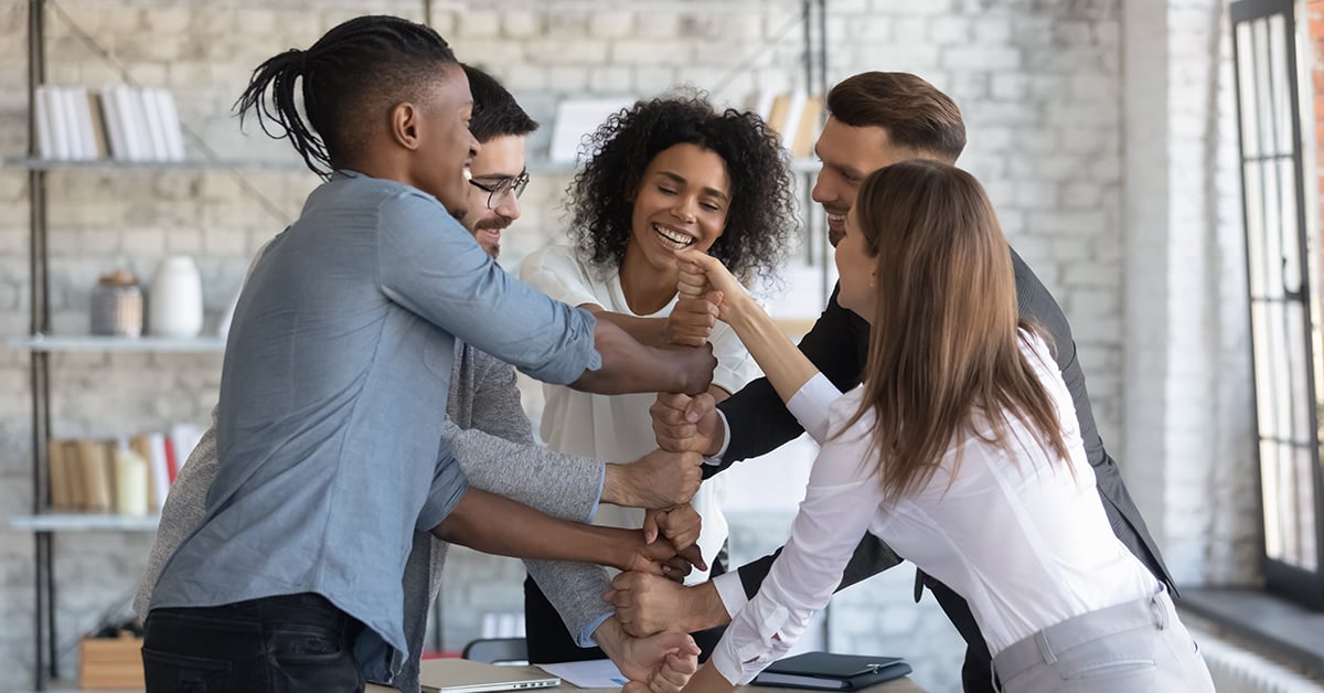 Group of company employees having fun in team building meeting.