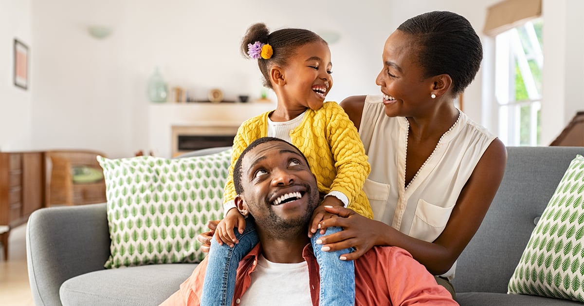 Two working parents enjoy spending time with their child.