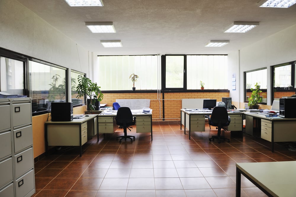 empty office with tile floors and windows