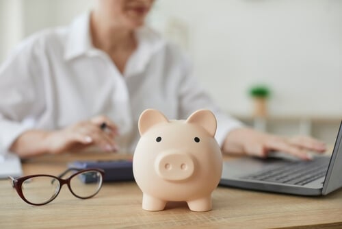 employee-saving-for-retirement-by-putting-money-in-piggy-bank